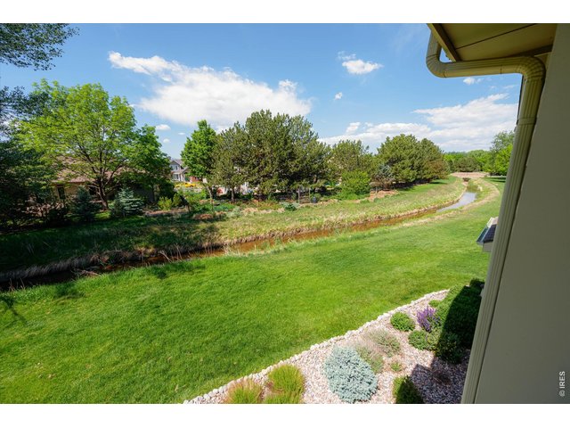 Property Photo 10 View from the living room overlooking beautifully maintained green space cared for by the HOA.