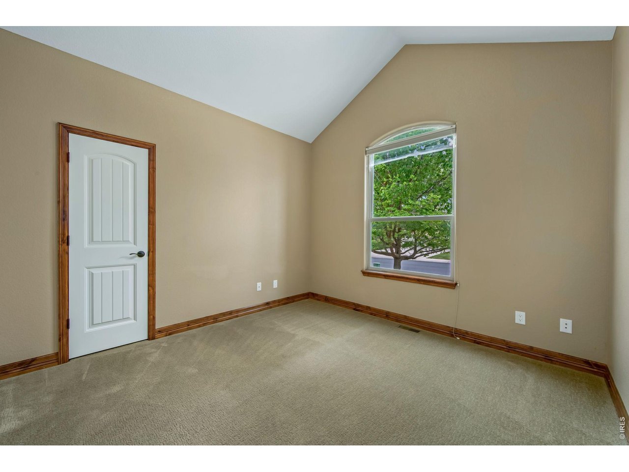 Bedroom 2 at the front of the house with a large walk in closet and vaulted ceilings!