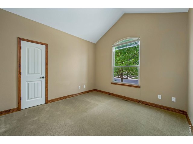 Property Photo 23 Bedroom 2 at the front of the house with a large walk in closet and vaulted ceilings!