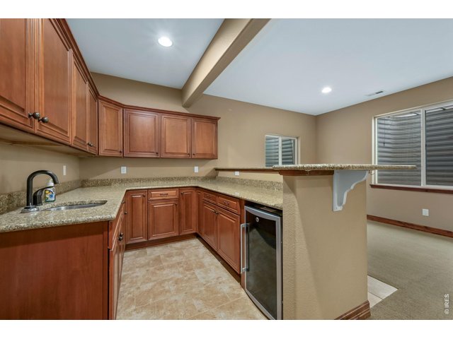 Property Photo 29 Wet bar with granite counters, and beverage refrigerator 