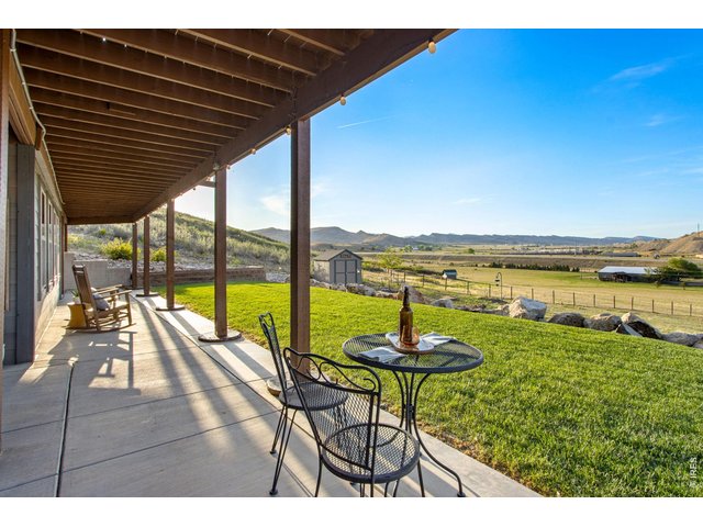 Property Photo 15 Upper level and lower level back patios overlooking your land and the pond
