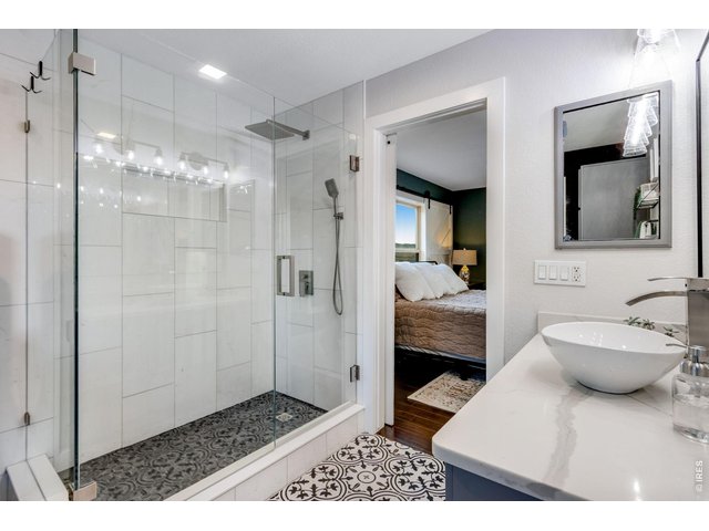 Property Photo 35 Private and updated primary bedroom 3/4 bath with vessel sink and custom tile flooring and backsplash 