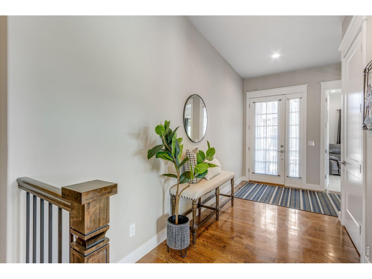 View of front entry way - notice the extra wide hallway, hardwood floors, 10' ceilings and custom hand-troweled drywall texture