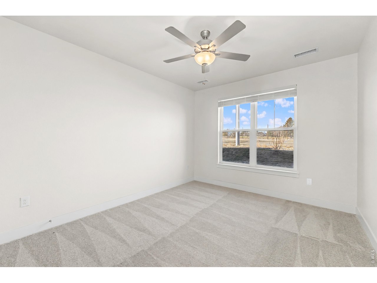Property Photo 9 Primary bedroom with ceiling fan included. 