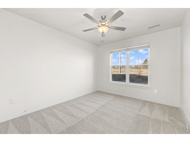 Property Photo 9 Primary bedroom with ceiling fan included. 