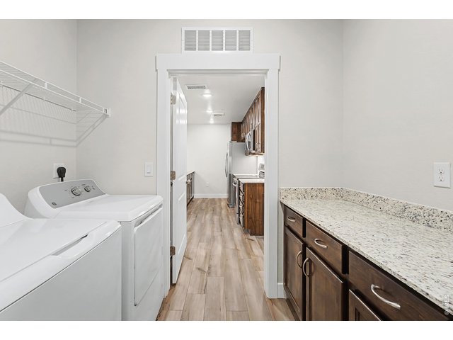 Property Photo 8 Laundry room with built in cabinets and quartz countertop + washer and dryer included! 