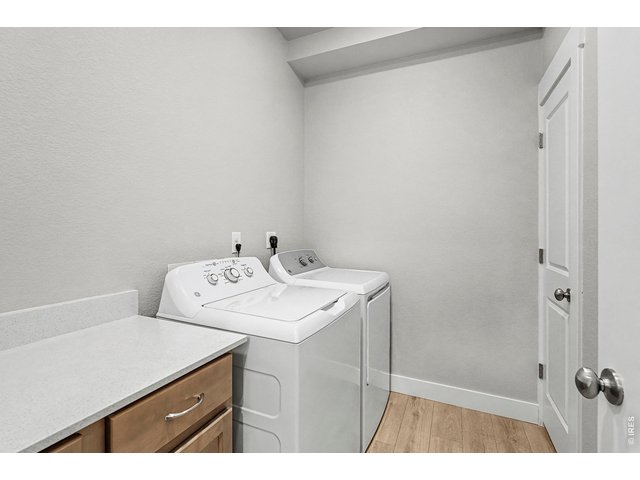 Property Photo 9 Laundry room with built in cabients & quartz countertops. Washer & Dryer included! 