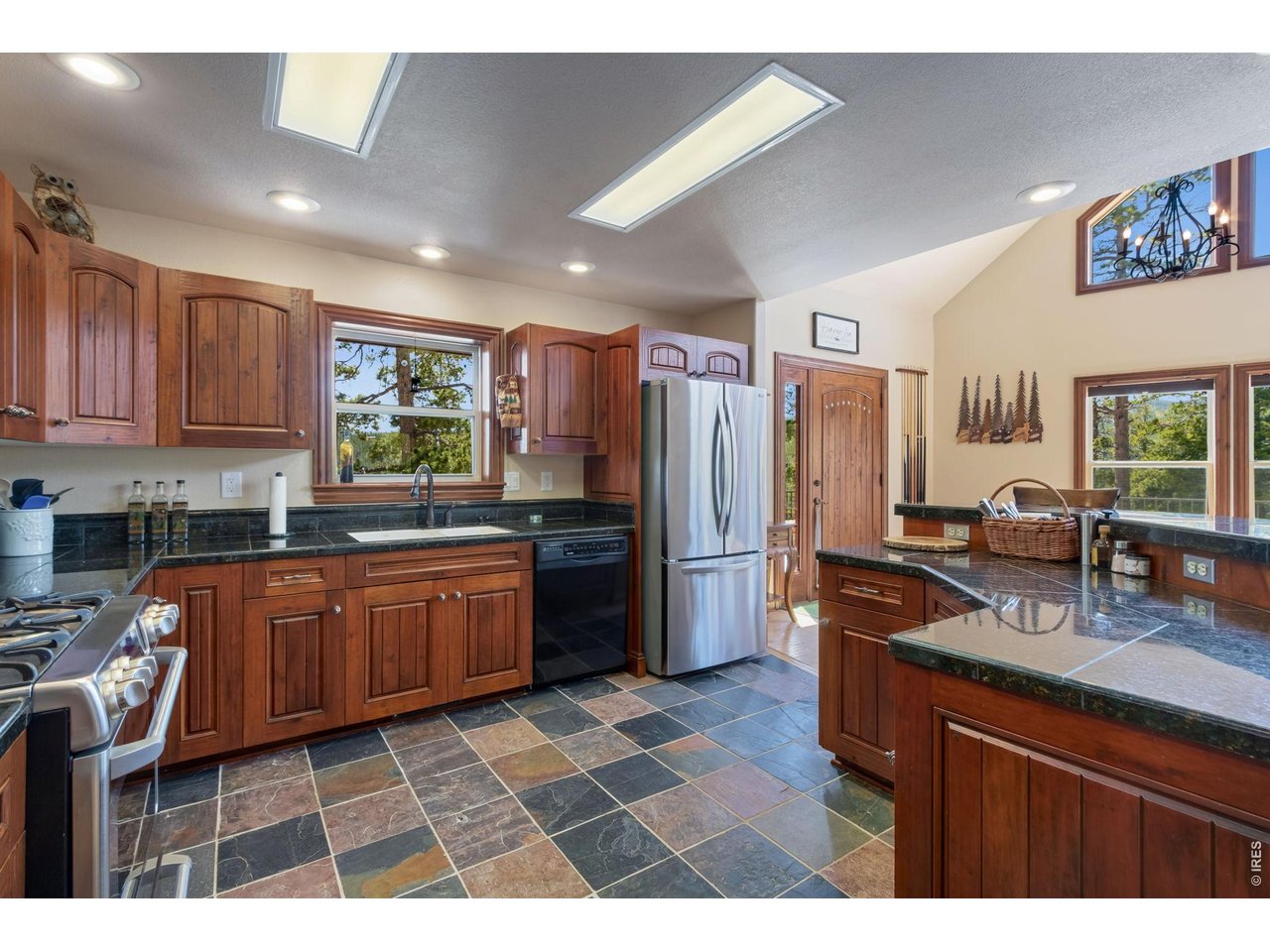 Beautiful hardwood cabinetry and granite tile countertops. Slate flooring for easy cleanups.