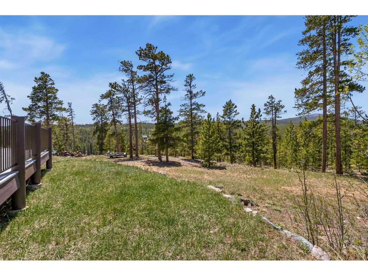 View from the West Deck. There is a secondary driveway here for guests or camper. And, there is a horseshoe pit just down the way. 