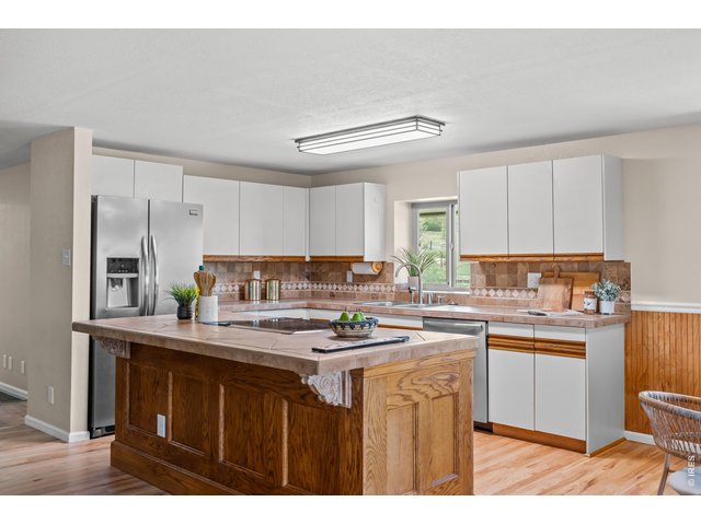 Property Photo 6 Big, open eat-in kitchen with stainless fridge and new SS dishwasher. Oversized island.