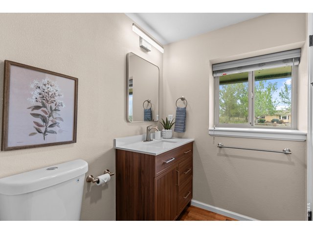 Property Photo 22 Main Full Bath with all new fixtures, vanity, lighting, flooring, toilet and tile shower.