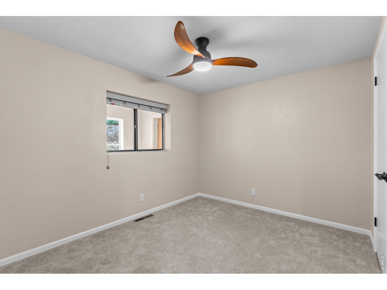 2nd Bedroom with fresh carpet, paint and light fixture.