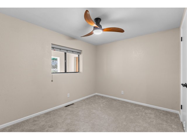 Property Photo 20 2nd Bedroom with fresh carpet, paint and light fixture.
