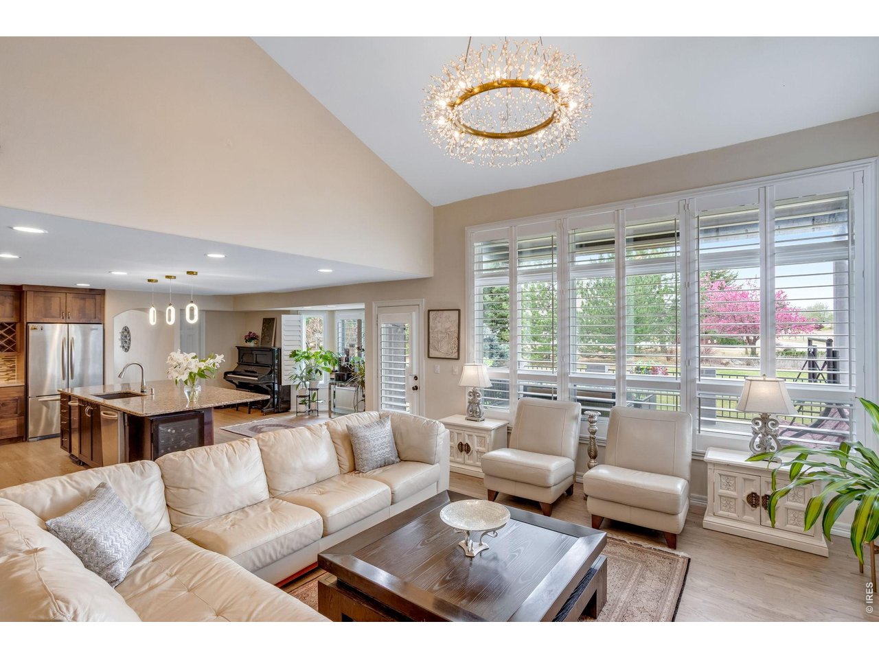 Bright main level living space - airy volume ceilings. Crisp white casing and trim - with elegant plantation shutters.