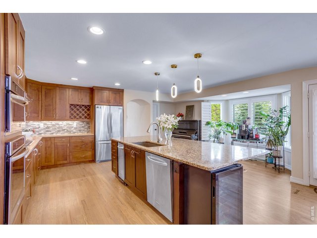 Property Photo 15 Huge slab granite island double wall ovens (top one converts to microwave), 5 burner gas cooktop, stainless appliances.