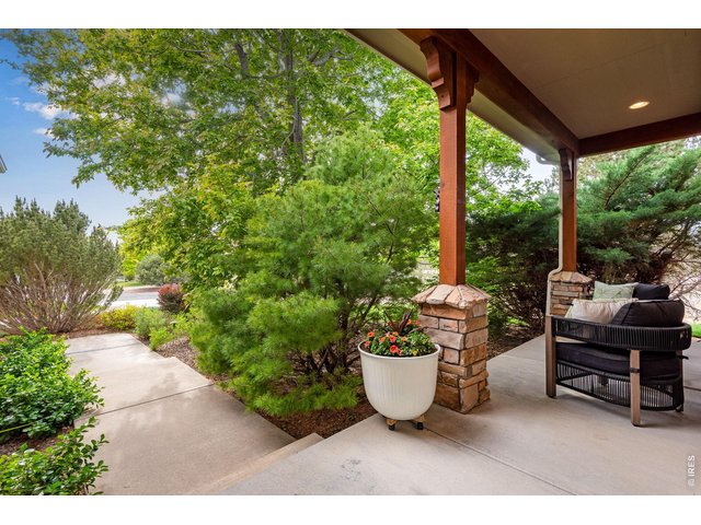 Property Photo 7 West Facing, covered front porch area, establish lush landscaping all around the home. 