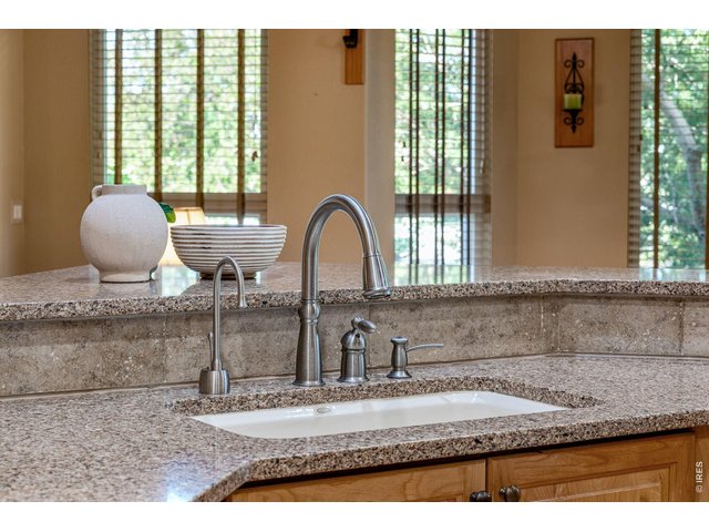 Property Photo 23 Instant hot - for the intentional cook, Quartz silestone countertops and travertine splash.