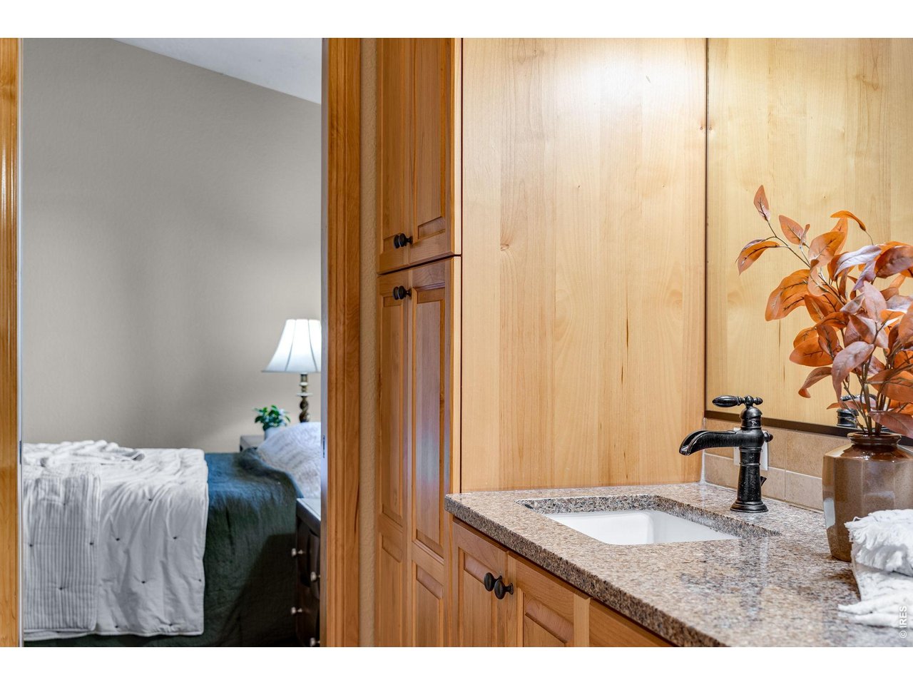 Great storage in the primary bathroom - alder cabinetry and upgraded open channel Delta oil rubbed bronze faucets.