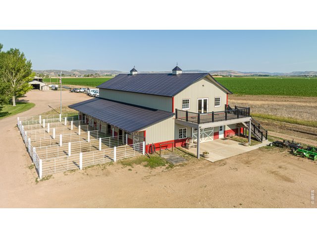 Property Photo 9 Equestrian amenities are anchored by a 3,888 sq. ft. barn featuring 6 stalls each w/ private runs, tack room, wash bay, hay storage, a 2,232 sq ft loft, main-level concrete patio, & upper-level observation deck.