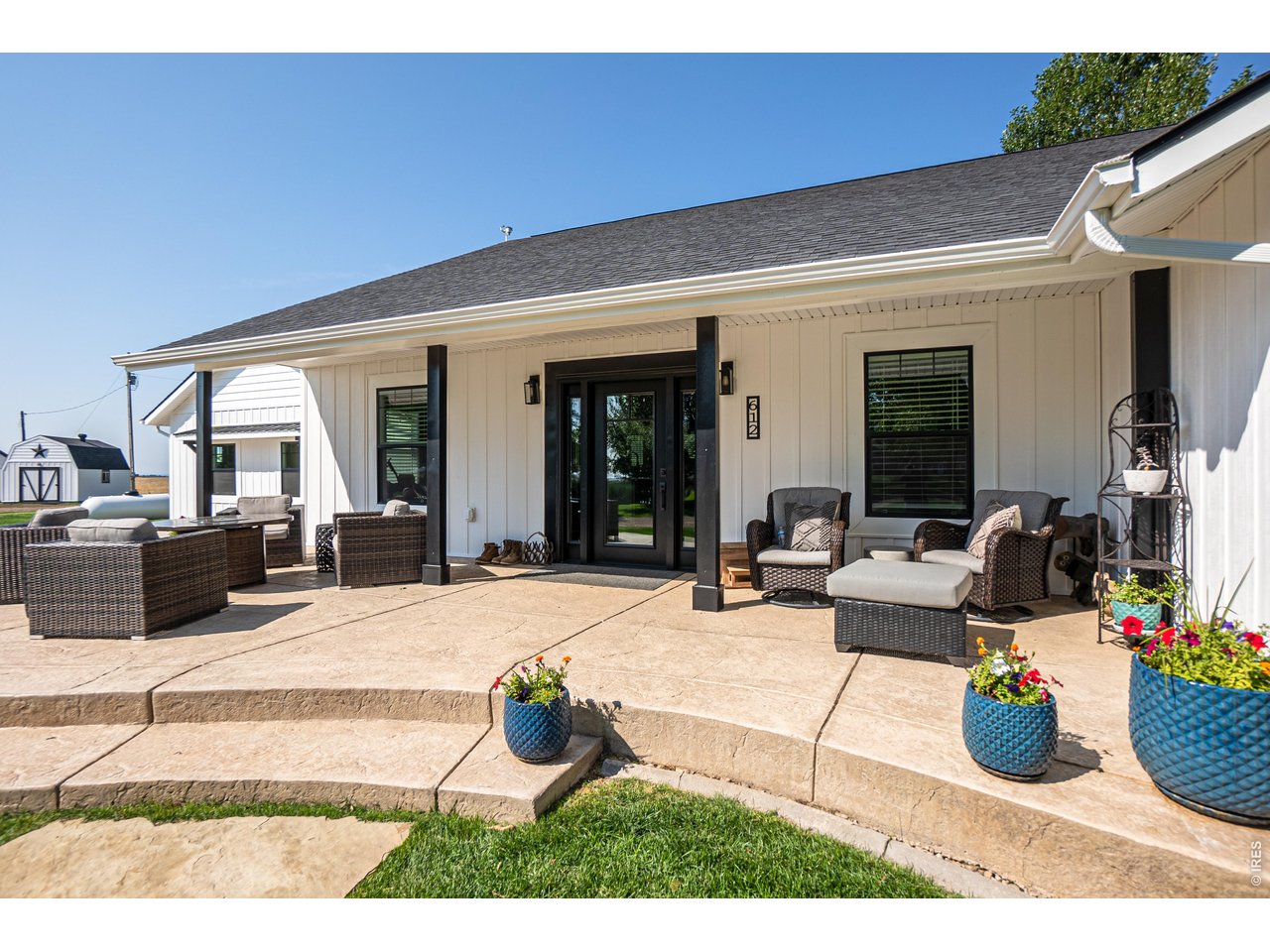 East facing front covered patio with stamped concrete. Enjoy the peaceful daily sunrise over your private pond.