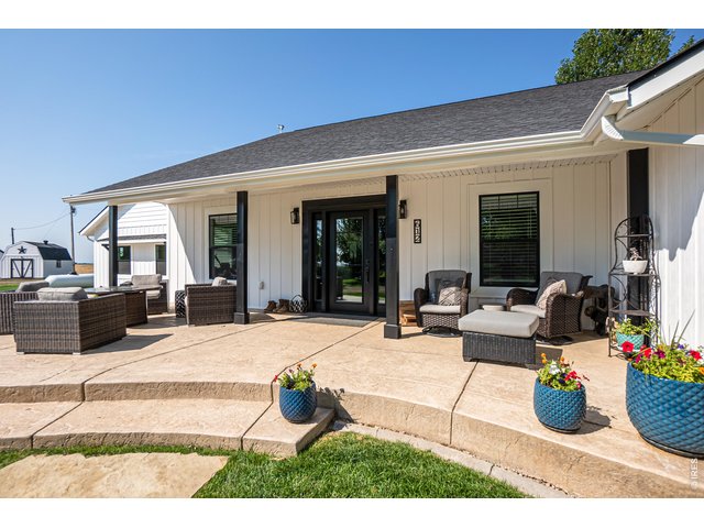 Property Photo 22 East facing front covered patio with stamped concrete. Enjoy the peaceful daily sunrise over your private pond.