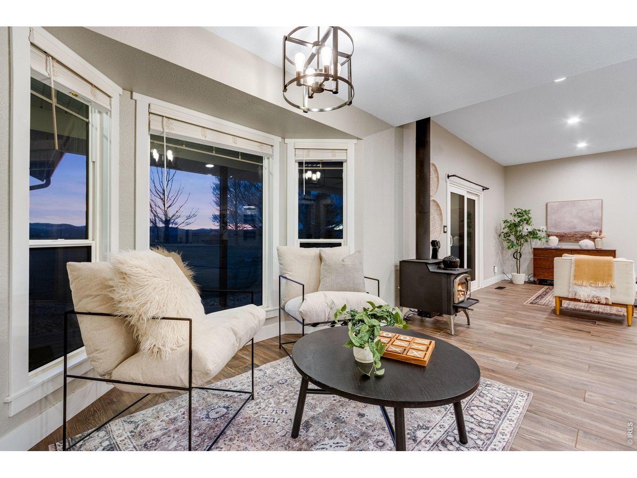 Breakfast nook with bay window overlooking the Rocky Mountains. Wood burning fireplace separates this dining area from the living area