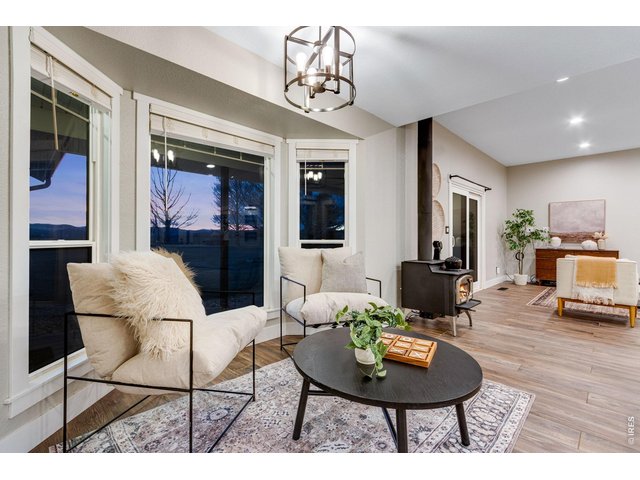 Property Photo 29 Breakfast nook with bay window overlooking the Rocky Mountains. Wood burning fireplace separates this dining area from the living area