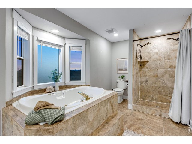 Property Photo 38 Primary bath features this jetted soaking tub and shower with 2 wands
