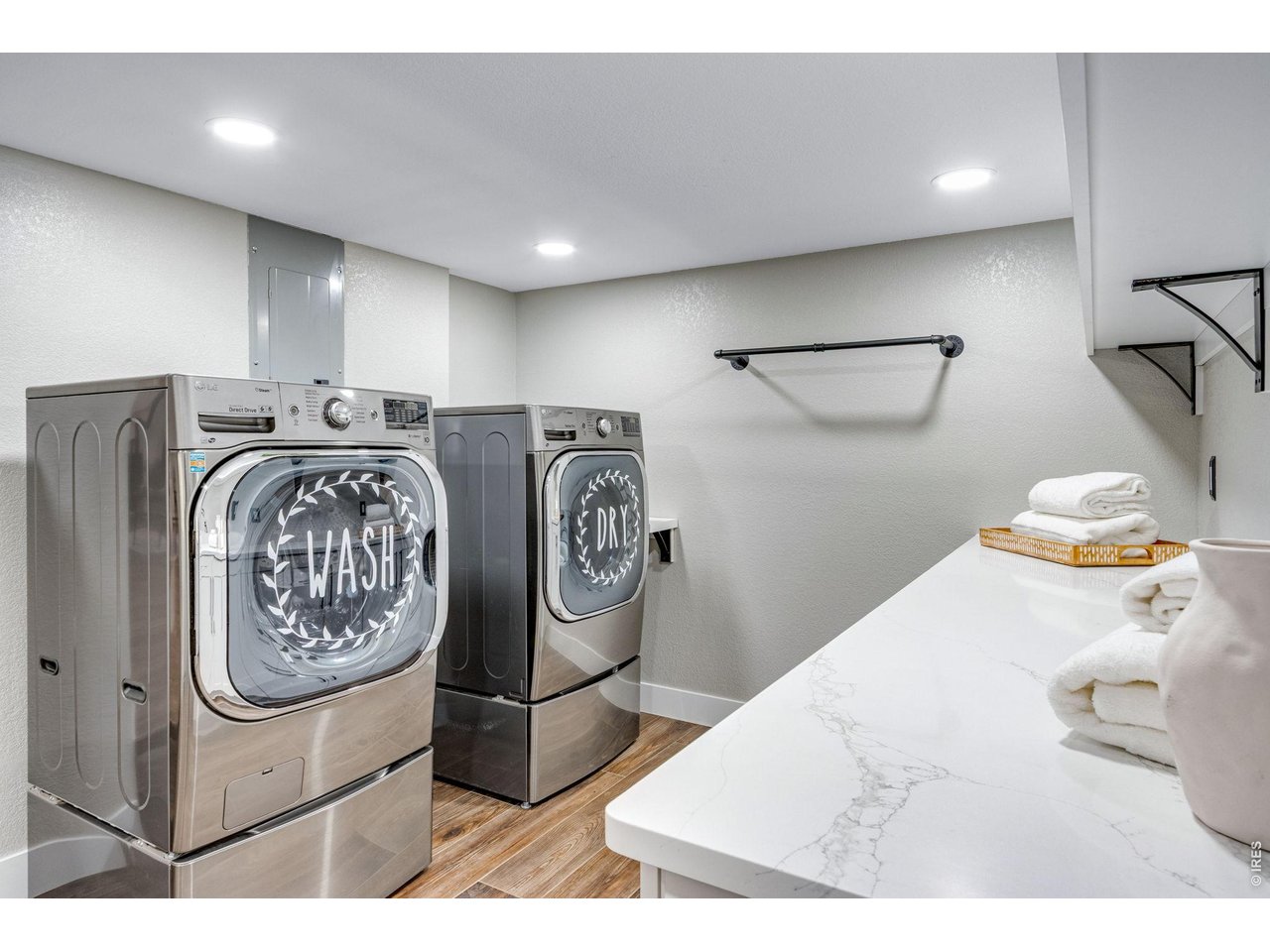 Massive laundry room designed for everyday efficiency and includes a mini refrigerator and ice-maker.