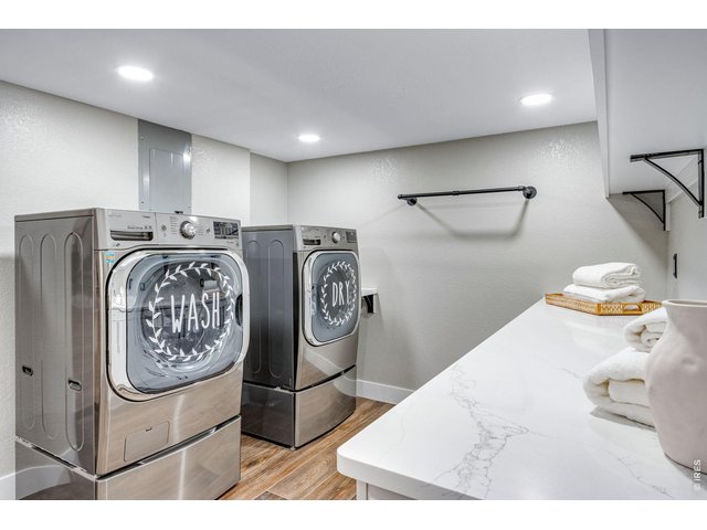 Property Photo 43 Massive laundry room designed for everyday efficiency and includes a mini refrigerator and ice-maker.