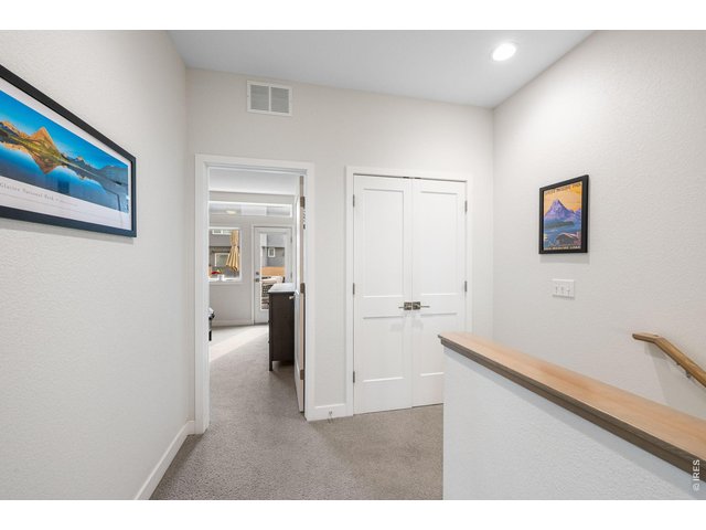 Property Photo 15 Hallway + laundry closet with view of primary suite