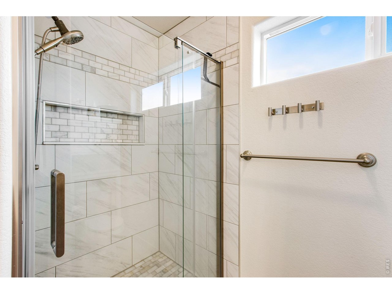 Remodeled tile shower in primary bathroom