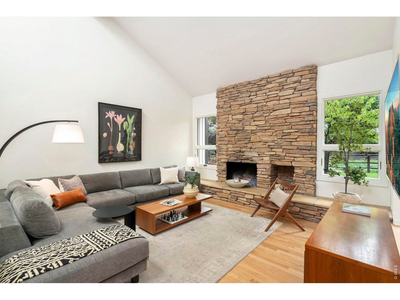 Main level living room with soaring ceilings and abundant natural light throughout. 