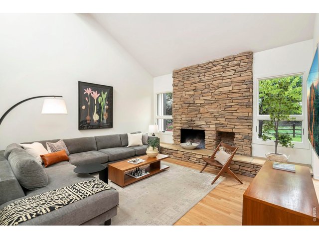 Property Photo 6 Main level living room with soaring ceilings and abundant natural light throughout. 