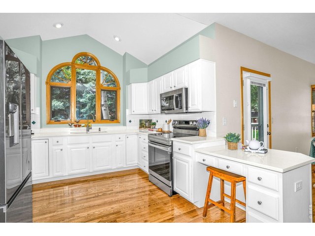 Property Photo 6 The Kitchen boasts a large picture window that brings the outdoors in!