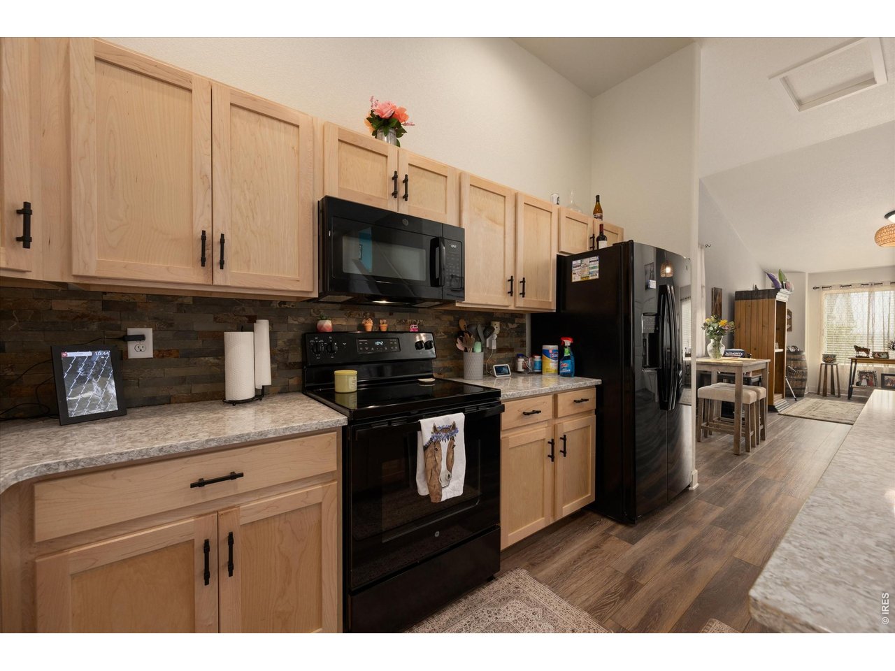Stone Backsplash, Sleek Black Appliances, Natural Light Pours In!