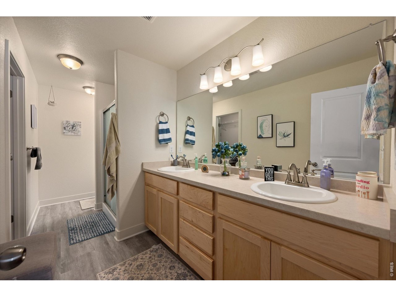 Double Sinks, Natural Cabinetry, Laminate Flooring
