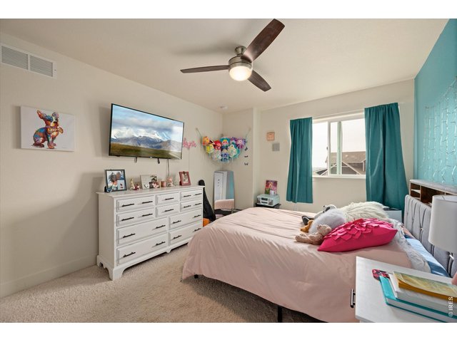 Property Photo 24 Secondary Bedroom with Large Window and Ceiling Fan!