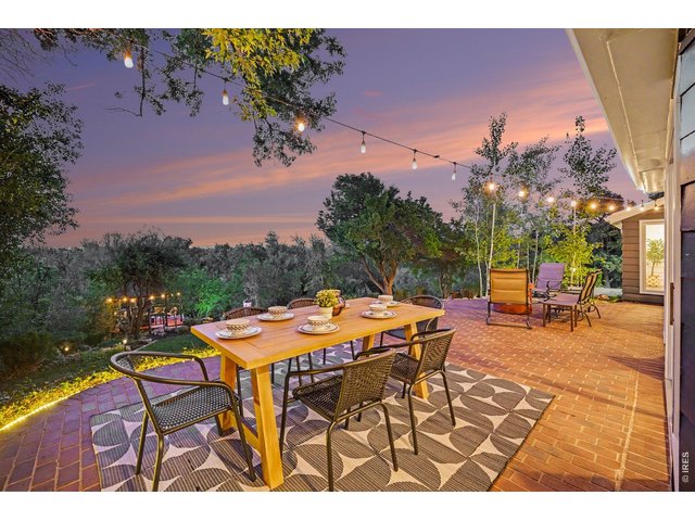 Property Photo 41 Outdoor dining at its absolute finest! This remarkable view showcases a resort-style brick patio layout designed for large-scale entertaining, completely immersed in a quiet, exceptionally private nature setting.