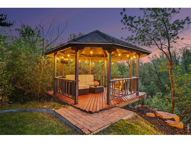 Property Photo 45 Experience peaceful nights in this beautiful covered gazebo, complete with comfortable lounge seating and ambient lighting in a secluded nature setting.