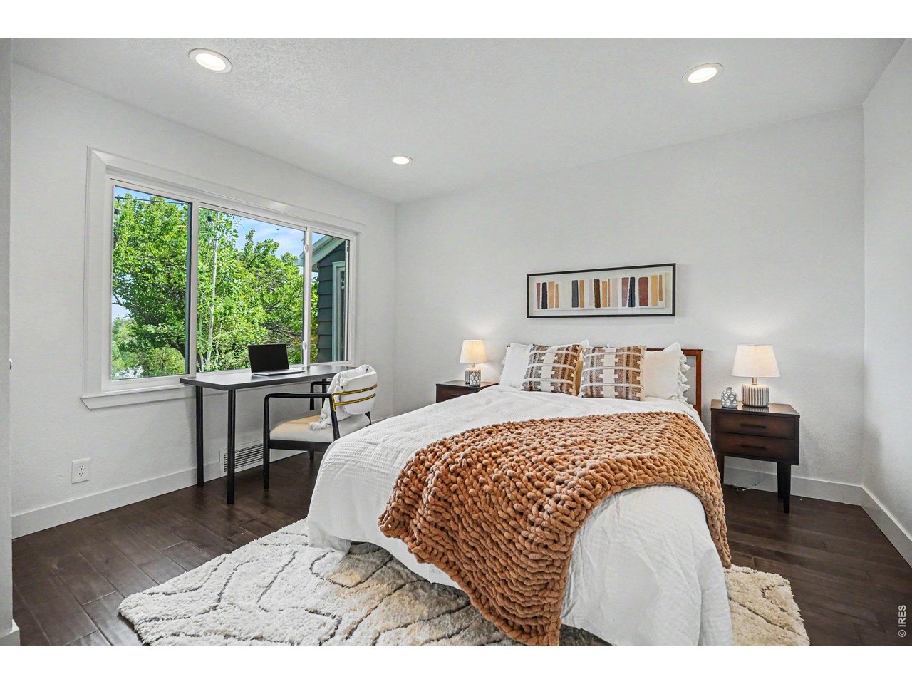 Bright and versatile secondary bedroom. Perfect as a guest room or home office space, with a large window framing gorgeous views of the mature backyard trees.