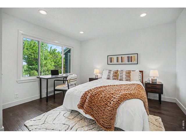 Property Photo 16 Bright and versatile secondary bedroom. Perfect as a guest room or home office space, with a large window framing gorgeous views of the mature backyard trees.
