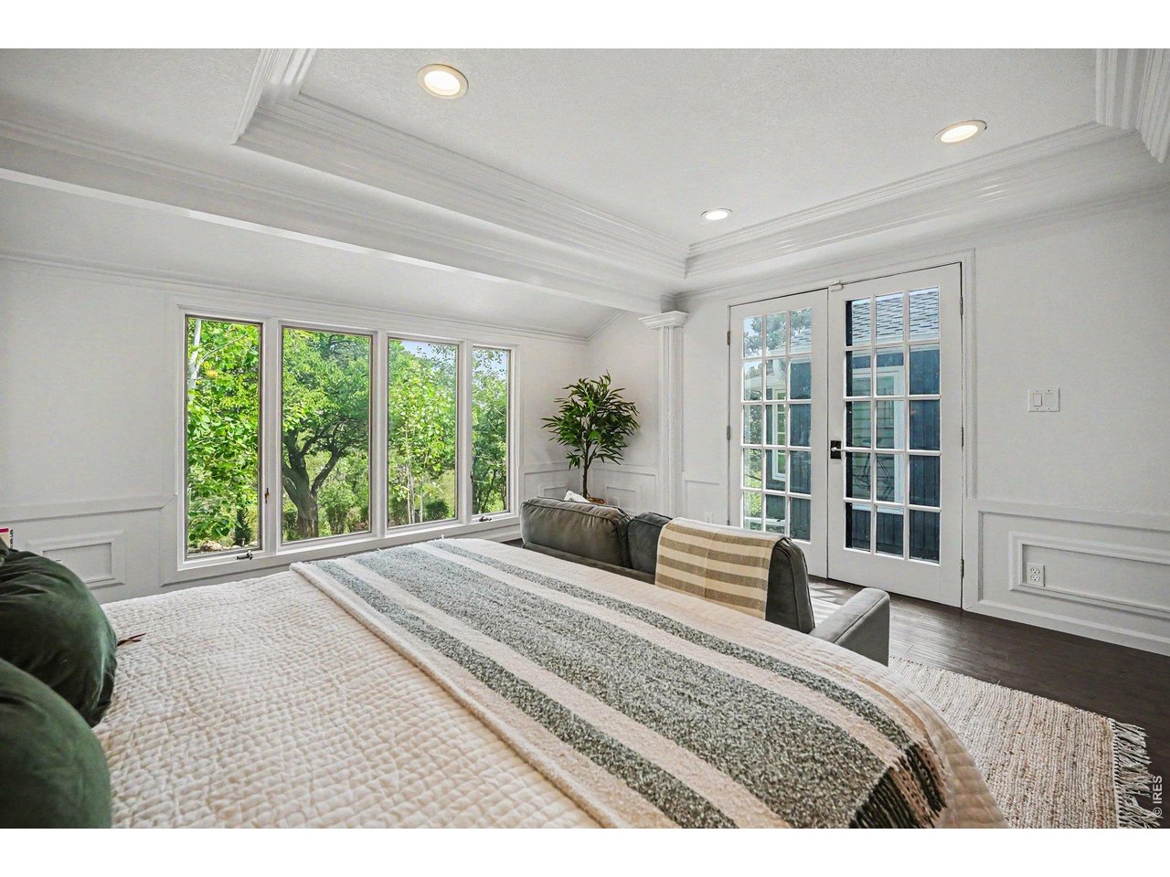 Wake up to spectacular views! The luxurious primary suite features elegant French doors that open directly to the private back patio, seamlessly connecting your indoor sanctuary with the peaceful, tree-lined backyard oasis.