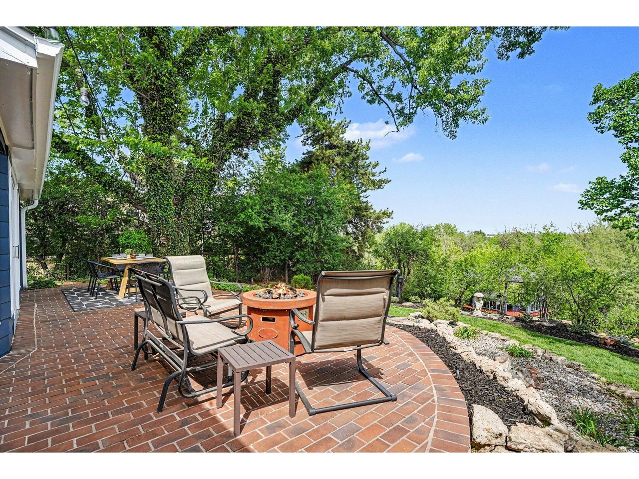 Outdoor living at its finest. This beautiful brick patio is perfect for a fire pit lounge overlooking the private yard space.