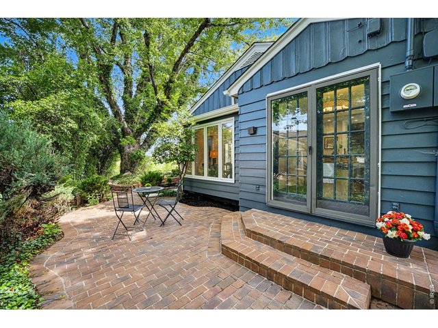 Property Photo 27 A peaceful retreat right outside your door. This private brick courtyard patio sits just off the dining space, framed by mature trees and lush greenery-the perfect spot for a bistro set and your morning coffee