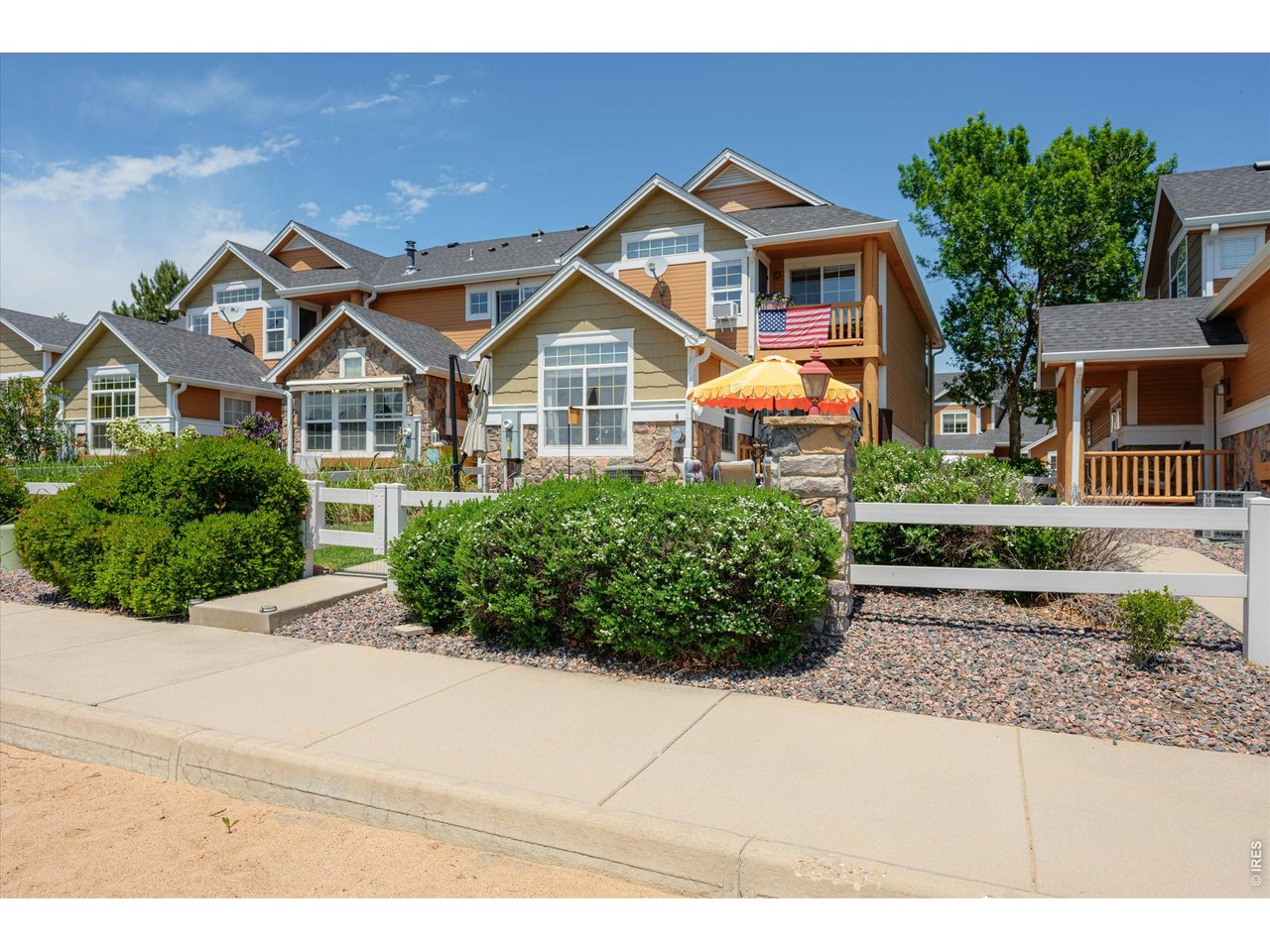 Lock & Leave to Enjoy 27 Holes of Golf, Lakes, Pool, Restaurants, Clubhouse, Trails, Parks, Tennis-All Golf Cart Accessible! View of Front of Townhome- Primary Bedroom Has Balcony Overlooking the Lake!