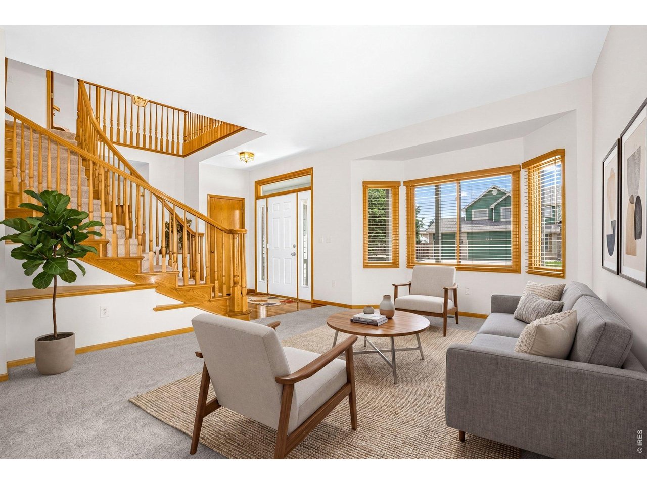 The living room is filled with natural light and has neutral paint. 