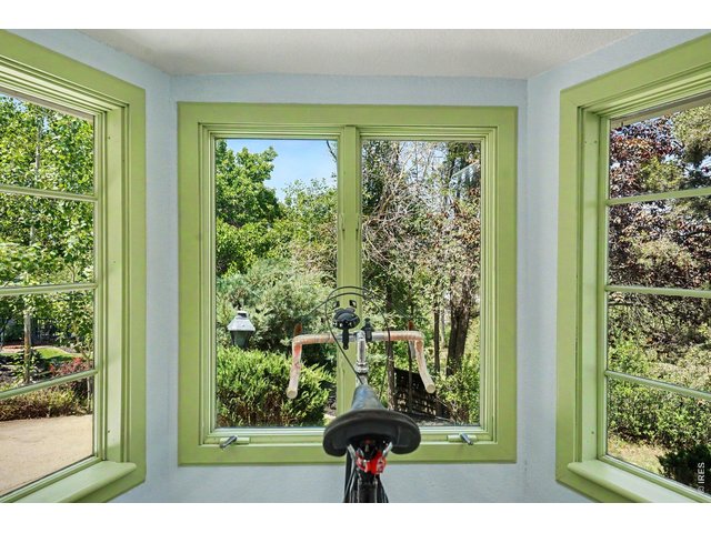 Property Photo 23 Flooded with natural light from multiple windows framing peaceful, leafy backyard views.