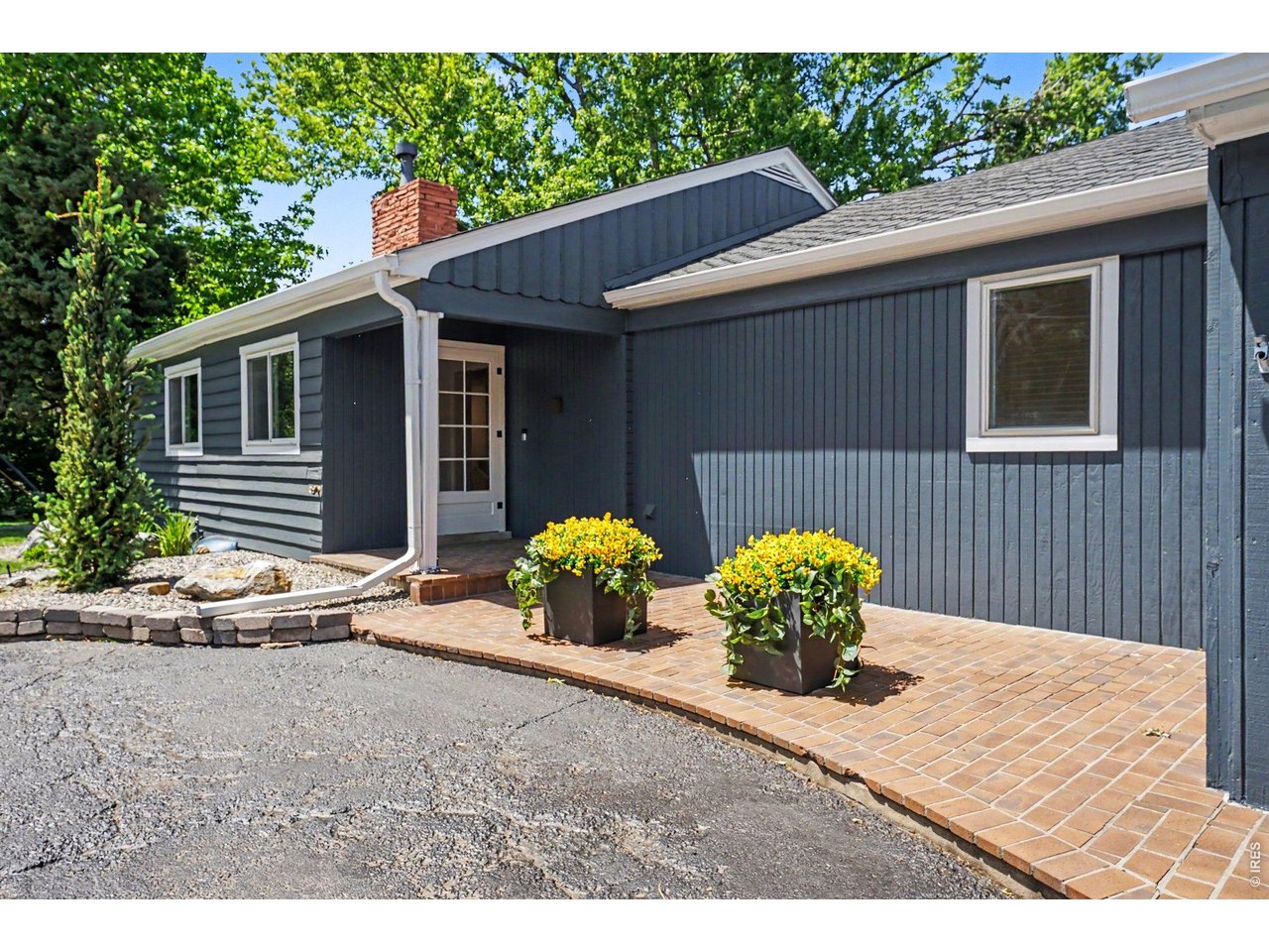 A welcoming brick walkway leads to the covered front entrance of this charming home.