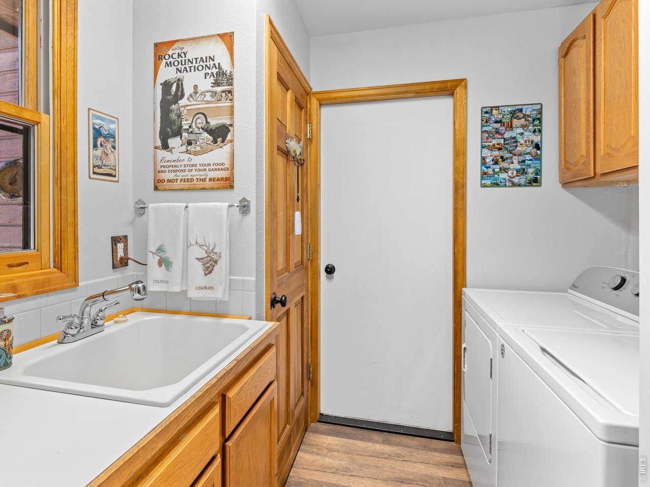 main level laundry room with large sink, exit to garage